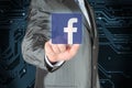 Businessman pushes Facebook icon