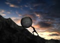 Businessman pushing concrete big stone uphill. man push hardly the concrete circle up to the top of mountain