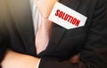 Businessman put card with text Solution in pocket. Business concept