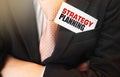 Businessman put card with text Strategy planning in pocket. Business concept