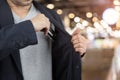 Businessman put out credit card in pocket on shop blur background