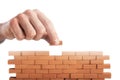 Businessman puts a brick to build a wall. Concept of new business, partnership, integration and startup