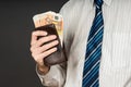 Businessman putting banknotes in his wallet. Stack of fifty euros money. Business man is holding cash. Person pays in euro bills Royalty Free Stock Photo