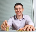 Businessman putting the coins in columns Royalty Free Stock Photo
