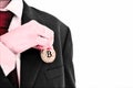 Businessman putting golden bit coin in pocket Royalty Free Stock Photo