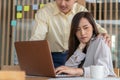 Businessman putting hand on the shoulder of female employee in office at work. She unhappy and feeling displeased with inappropria Royalty Free Stock Photo