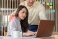 Businessman putting hand on the shoulder of female employee in office at work. She unhappy and feeling displeased with Royalty Free Stock Photo