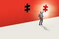 Businessman putting missing jigsaw puzzle piece Royalty Free Stock Photo