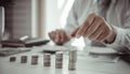 Businessman putting money on stacking coin that shows a graph the financial growth profit of business investment