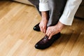 Businessman putting on shoes, man getting ready for work, groom morning before wedding ceremony Royalty Free Stock Photo