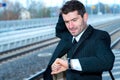 Businessman on railroad station in hastiness