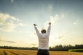 Businessman Raising Arms for Success at the Field