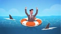 Businessman raising hands inside lifebuoy in water full of shark helping business to survive help support financial Royalty Free Stock Photo