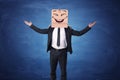 Businessman raising hands up and wearing box on his head with laughing face painted Royalty Free Stock Photo