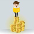 Businessman reading a book on a pile of gold coins Royalty Free Stock Photo