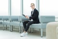 Businessman reading a business document sitting in the office lobby Royalty Free Stock Photo