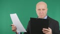 Businessman Reading Documents and Contracts with Green Screen in Background Royalty Free Stock Photo