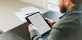 Businessman reading elecronic rental agreement on tablet. Royalty Free Stock Photo