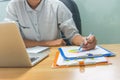 Businessman reading financial number on document report