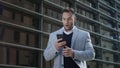 Businessman reading good news on smartphone. Man working on mobile phone Royalty Free Stock Photo