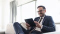 Businessman reading mails on a tablet Royalty Free Stock Photo