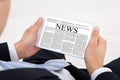 Businessman Reading News On Digital Tablet In Office Royalty Free Stock Photo