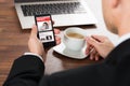 Businessman reading news while having coffee Royalty Free Stock Photo