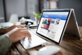 Businessman Reading News On Laptop At Desk Royalty Free Stock Photo