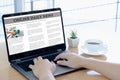 Businessman reading news on laptop at office desk Royalty Free Stock Photo