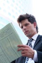 Businessman reading newspaper