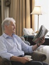 Businessman Reading Newspaper In Armchair Royalty Free Stock Photo