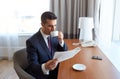 Businessman reading newspaper and drinking coffee Royalty Free Stock Photo