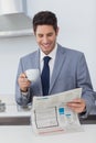Businessman reading a newspaper and drinking a coffee Royalty Free Stock Photo