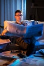 Businessman reading newspaper late at night Royalty Free Stock Photo