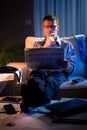 Businessman reading newspaper late at night Royalty Free Stock Photo