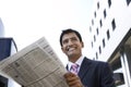 Businessman Reading Newspaper Outdoors Royalty Free Stock Photo