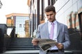 Businessman reading newspaper outdoors Royalty Free Stock Photo