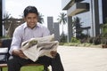 Businessman Reading Newspaper Outdoors Royalty Free Stock Photo