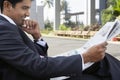 Businessman Reading Newspaper Outdoors Royalty Free Stock Photo