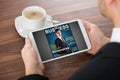 Businessman Reading Online Magazine On Digital Tablet Royalty Free Stock Photo