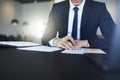 Businessman reading paperwork while sitting at his office desk Royalty Free Stock Photo