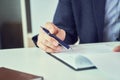 Businessman reading rental contract before making a deal. Corporate man with pen in hand working in modern office Royalty Free Stock Photo