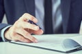 Businessman reading rental contract before making a deal. Corporate man with pen in hand working in modern office Royalty Free Stock Photo