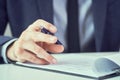 Businessman reading rental contract before making a deal. Corporate man with pen in hand working in modern office Royalty Free Stock Photo