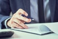 Businessman reading rental contract before making a deal. Corporate man with pen in hand working in modern office Royalty Free Stock Photo