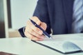 Businessman reading rental contract before making a deal. Corporate man with pen in hand working in modern office Royalty Free Stock Photo