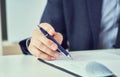 Businessman reading rental contract before making a deal. Corporate man with pen in hand working in modern office Royalty Free Stock Photo