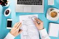 Businessman Reading Resume On Office Desk