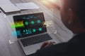 Businessman reads an information data interface on table is notebook, paper documents data screen