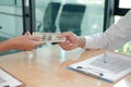 Businessman receiving money. woman giving cash banknote to man. bribery, corruption, venality concept Royalty Free Stock Photo